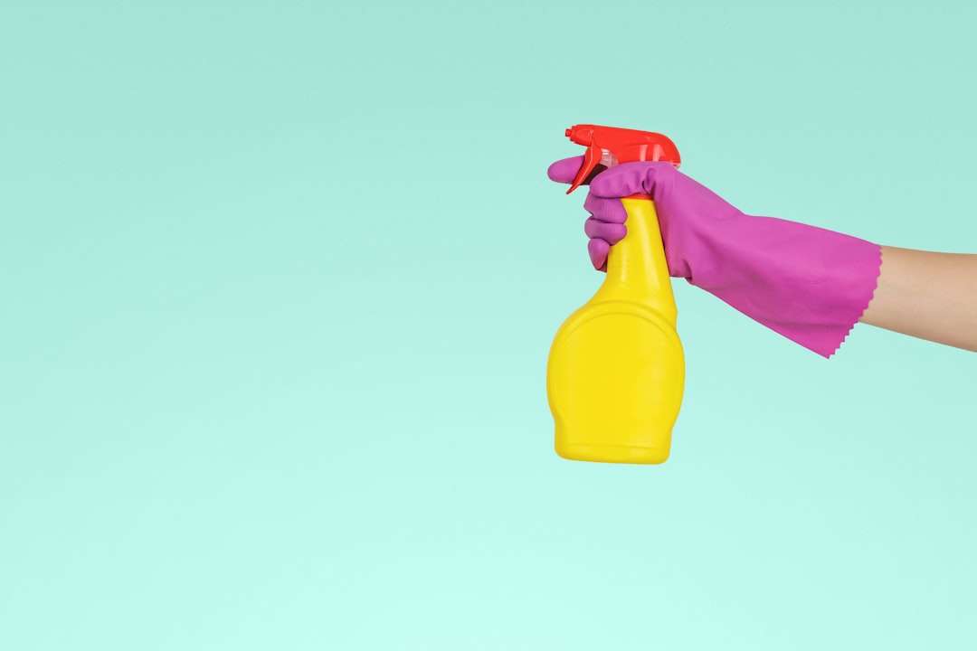 team-04 person-holding-yellow-plastic-spray-bottle-zmnefoi3k